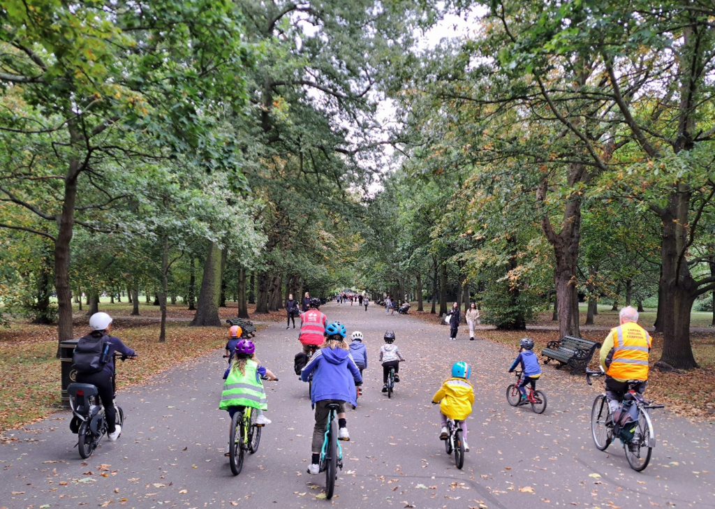 Children cycling through a park